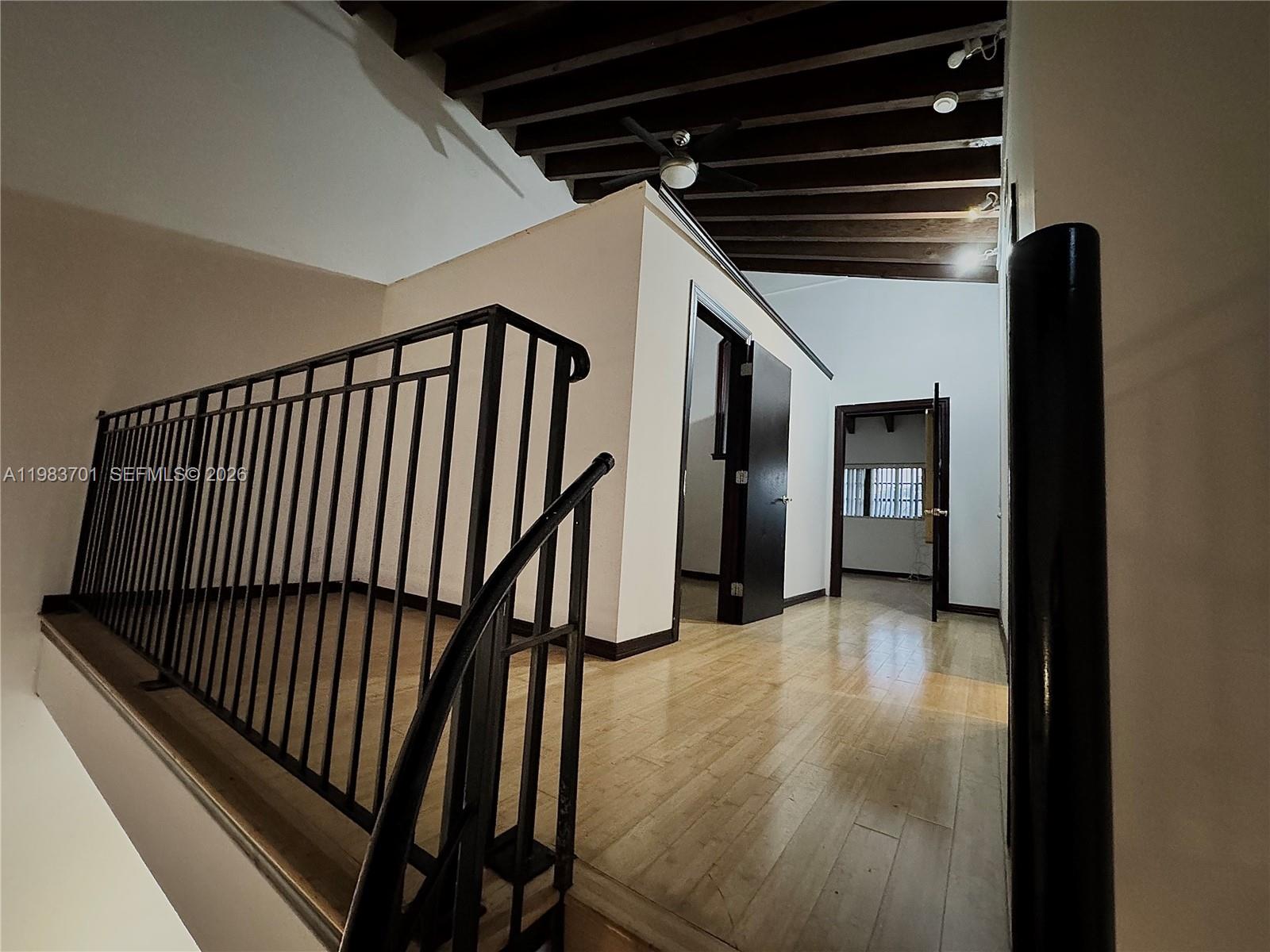 3911 Farragut Street Hollywood, FL 33021 - Photo 14 of 26 a view of a hallway with wooden floor and staircase