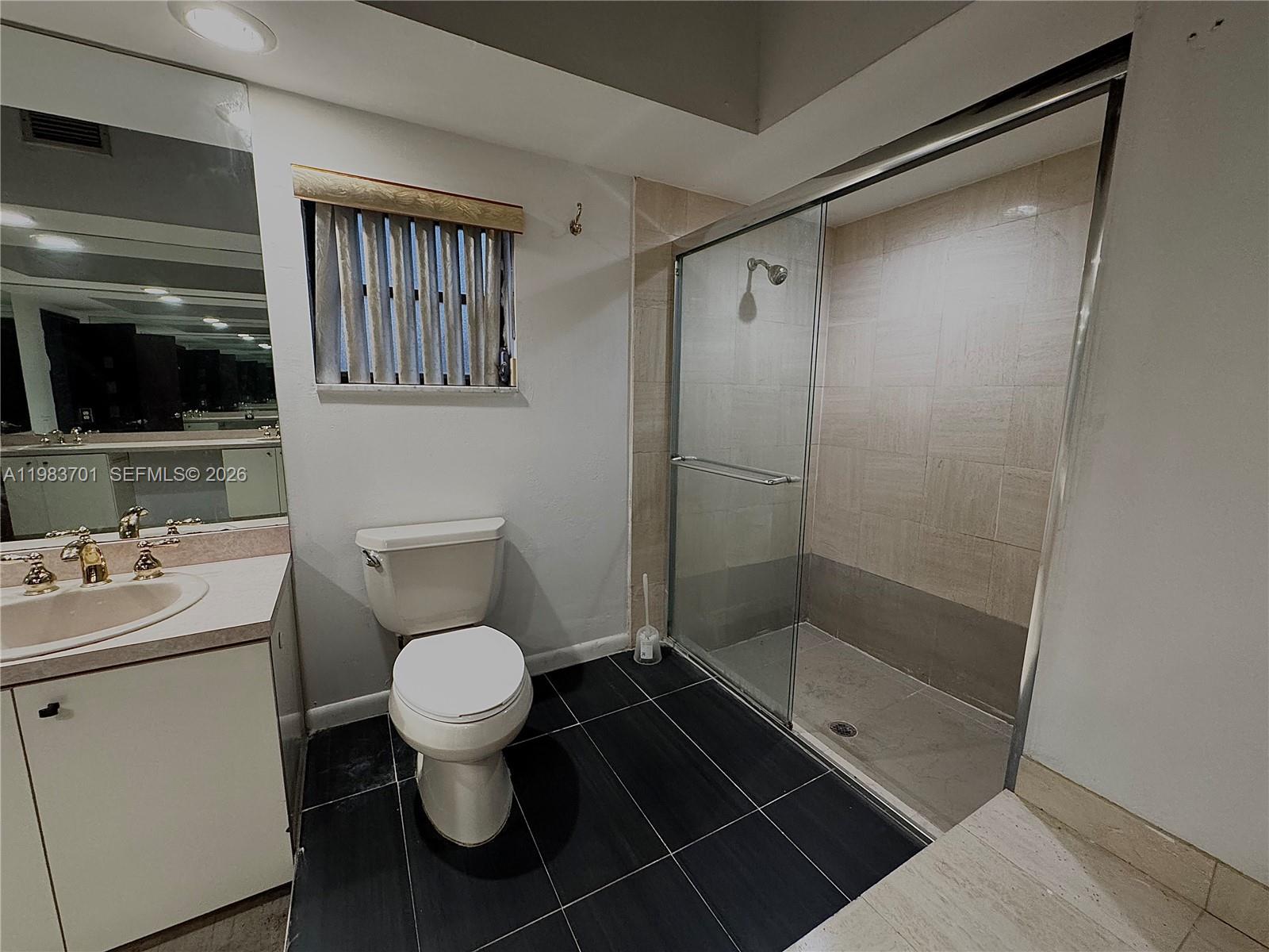 3911 Farragut Street Hollywood, FL 33021 - Photo 16 of 26 a bathroom with a toilet and a shower