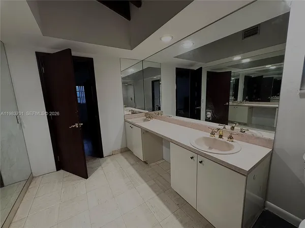 a bathroom with a double vanity sink and mirror