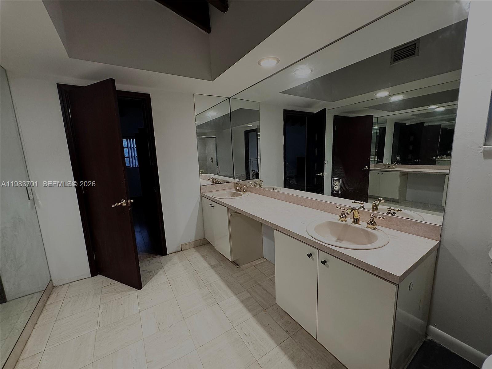 3911 Farragut Street Hollywood, FL 33021 - Photo 17 of 26 a bathroom with a double vanity sink and mirror