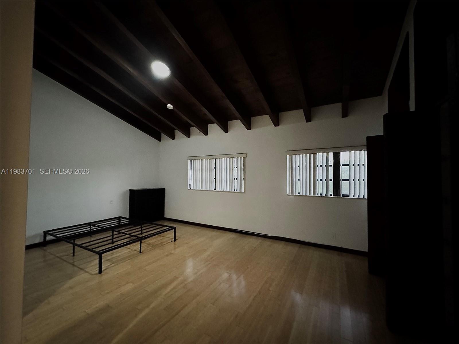 3911 Farragut Street Hollywood, FL 33021 - Photo 19 of 26 a room with wooden floor and a window