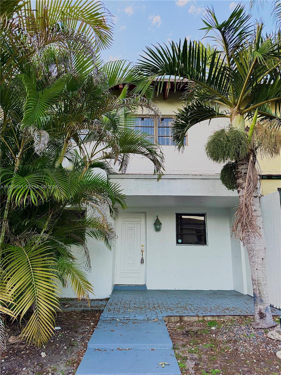 3911 Farragut Street Hollywood, FL 33021 - Photo 3 of 26 a front view of a house with a plant