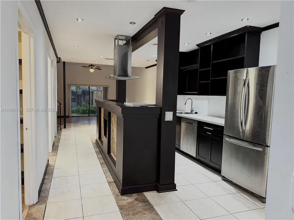 a kitchen with stainless steel appliances a refrigerator and a stove