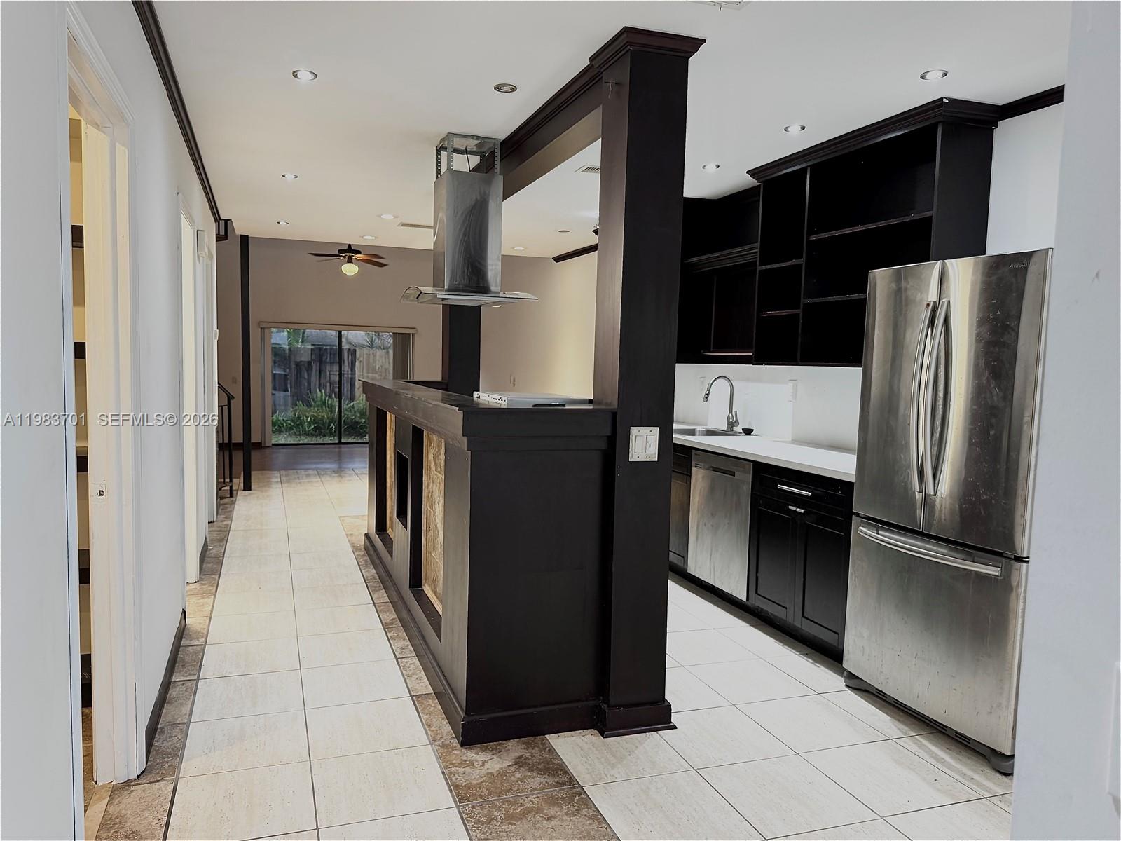 3911 Farragut Street Hollywood, FL 33021 - Photo 4 of 26 a kitchen with stainless steel appliances a refrigerator and a stove