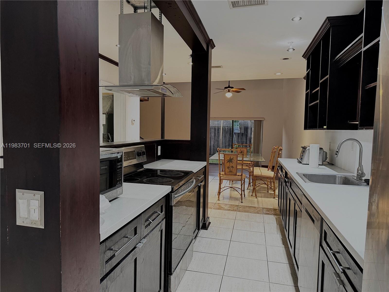 3911 Farragut Street Hollywood, FL 33021 - Photo 5 of 26 a kitchen with a sink stove and cabinets