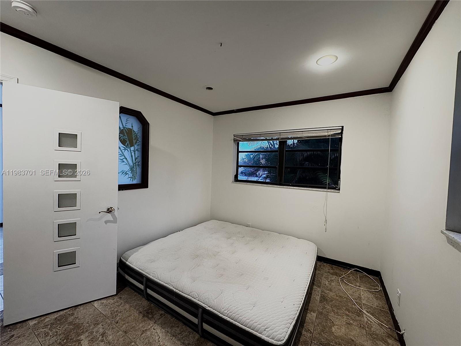 3911 Farragut Street Hollywood, FL 33021 - Photo 10 of 26 a bedroom with a bed and a wall painting