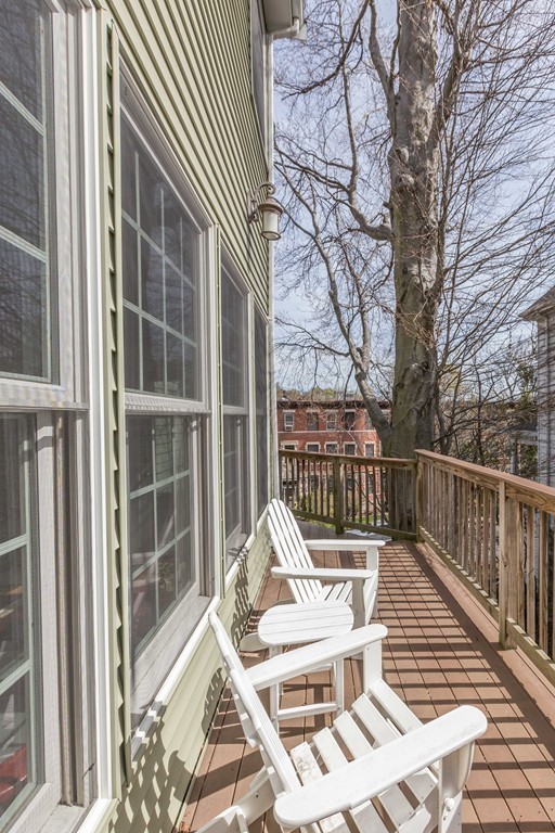 152 Winthrop Road, Unit 2 Brookline, MA 02445 - Photo 11 of 28 a view of balcony with two chairs and a large tree