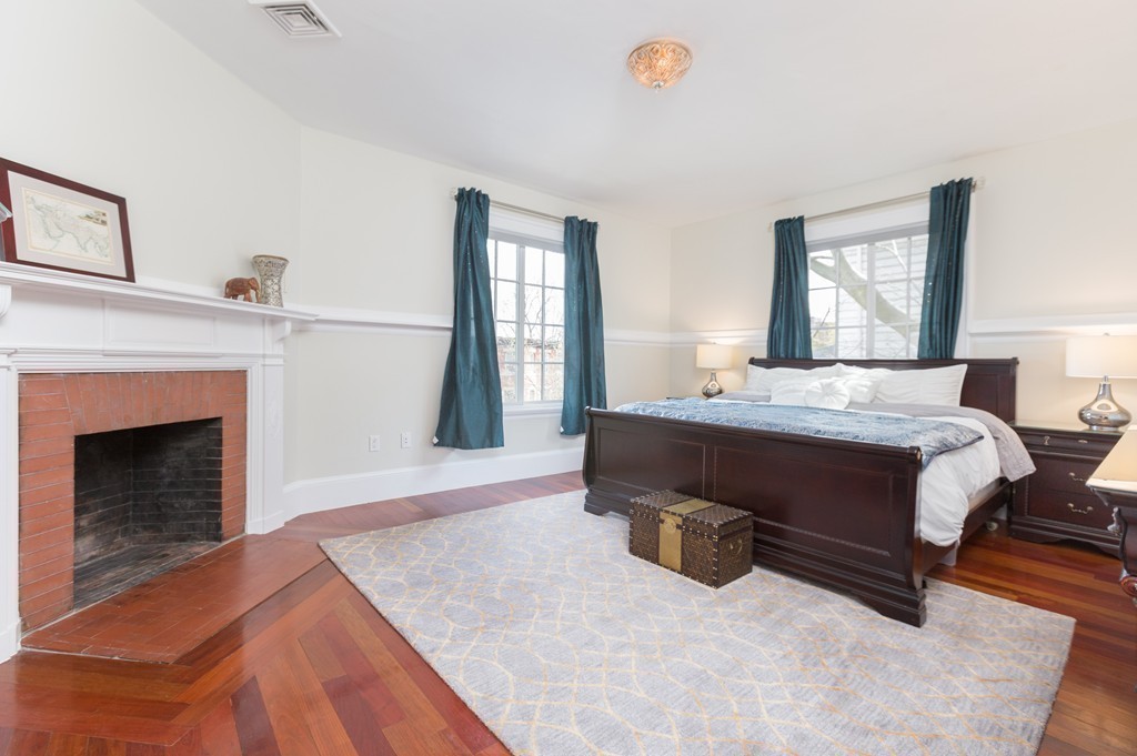 152 Winthrop Road, Unit 2 Brookline, MA 02445 - Photo 18 of 28 a bedroom with a bed and a fireplace