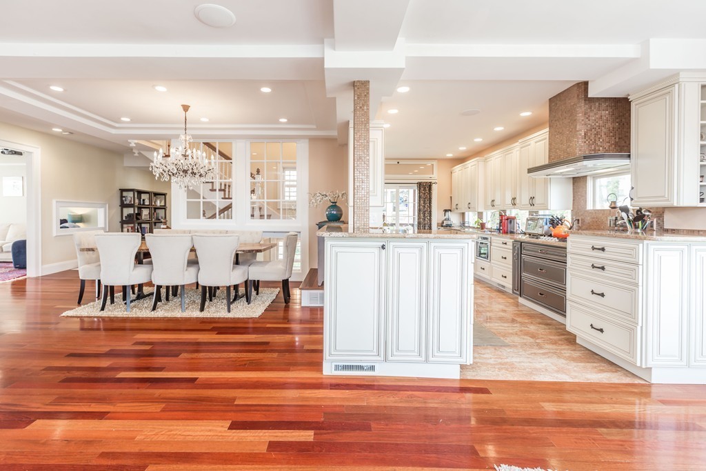 152 Winthrop Road, Unit 2 Brookline, MA 02445 - Photo 6 of 28 a large white kitchen with lots of counter space and chandelier