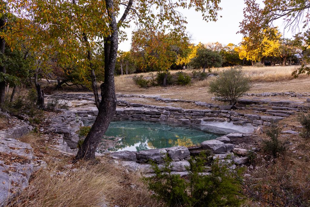 174 Cedar Rock Trail Southwest Hunt, TX 78024 - Photo 27 of 39 a view of a backyard of a house with a yard