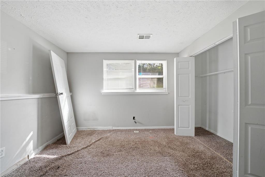 6865 Kimberly Mill Road Atlanta, GA 30349 - Photo 12 of 25 a view of an empty room with a window