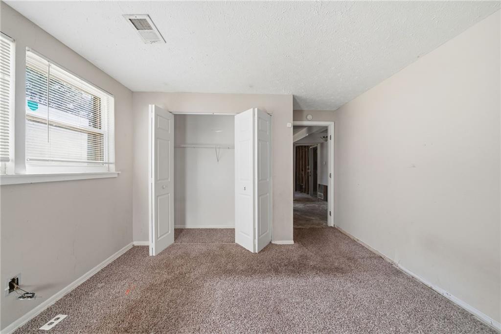 6865 Kimberly Mill Road Atlanta, GA 30349 - Photo 13 of 25 an empty room with windows and closet