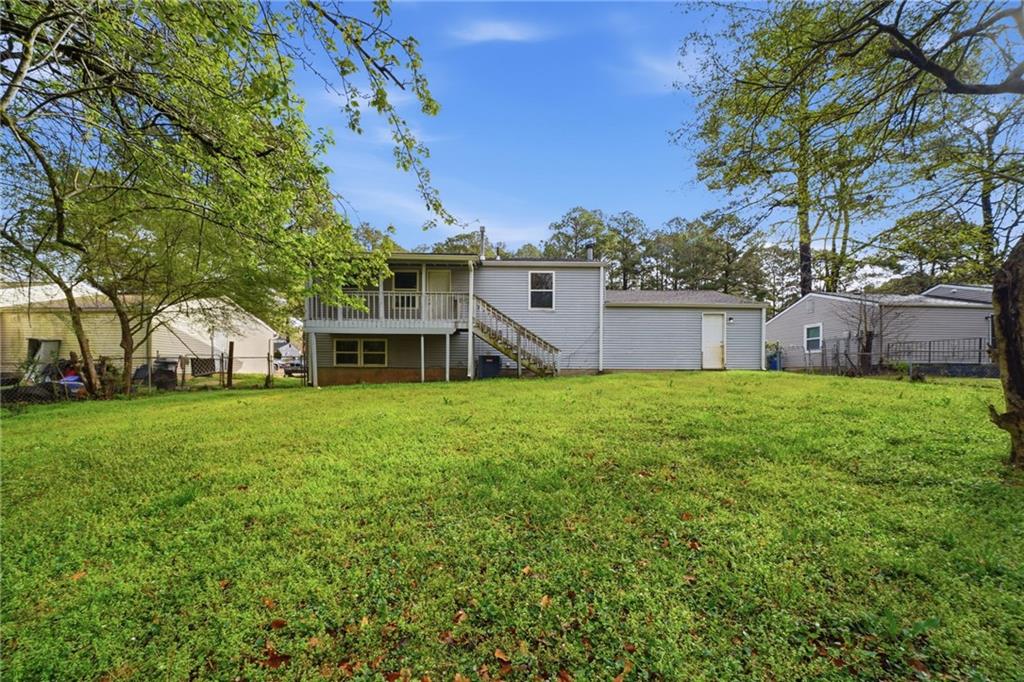 6865 Kimberly Mill Road Atlanta, GA 30349 - Photo 23 of 25 a front view of a house with garden