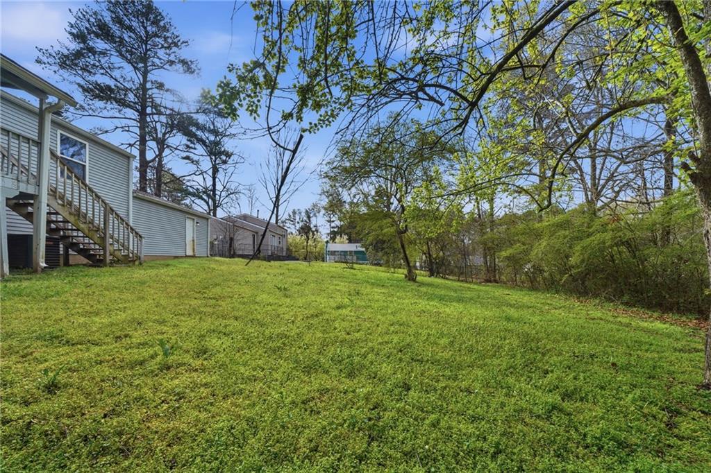 6865 Kimberly Mill Road Atlanta, GA 30349 - Photo 24 of 25 a view of a backyard with large trees