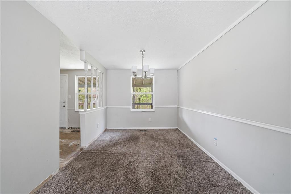 6865 Kimberly Mill Road Atlanta, GA 30349 - Photo 3 of 25 a view of an empty room with a window