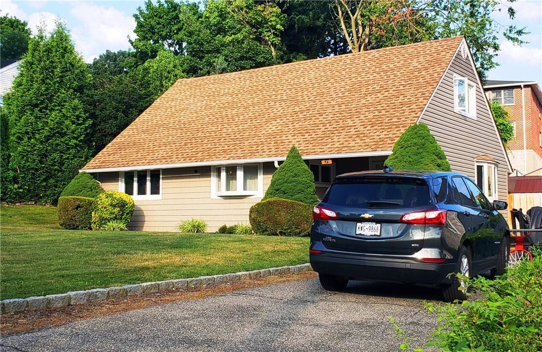 96 Whitman Road Yonkers, NY 10710 - Photo 1 of 1 a front view of a house with a garden and plants