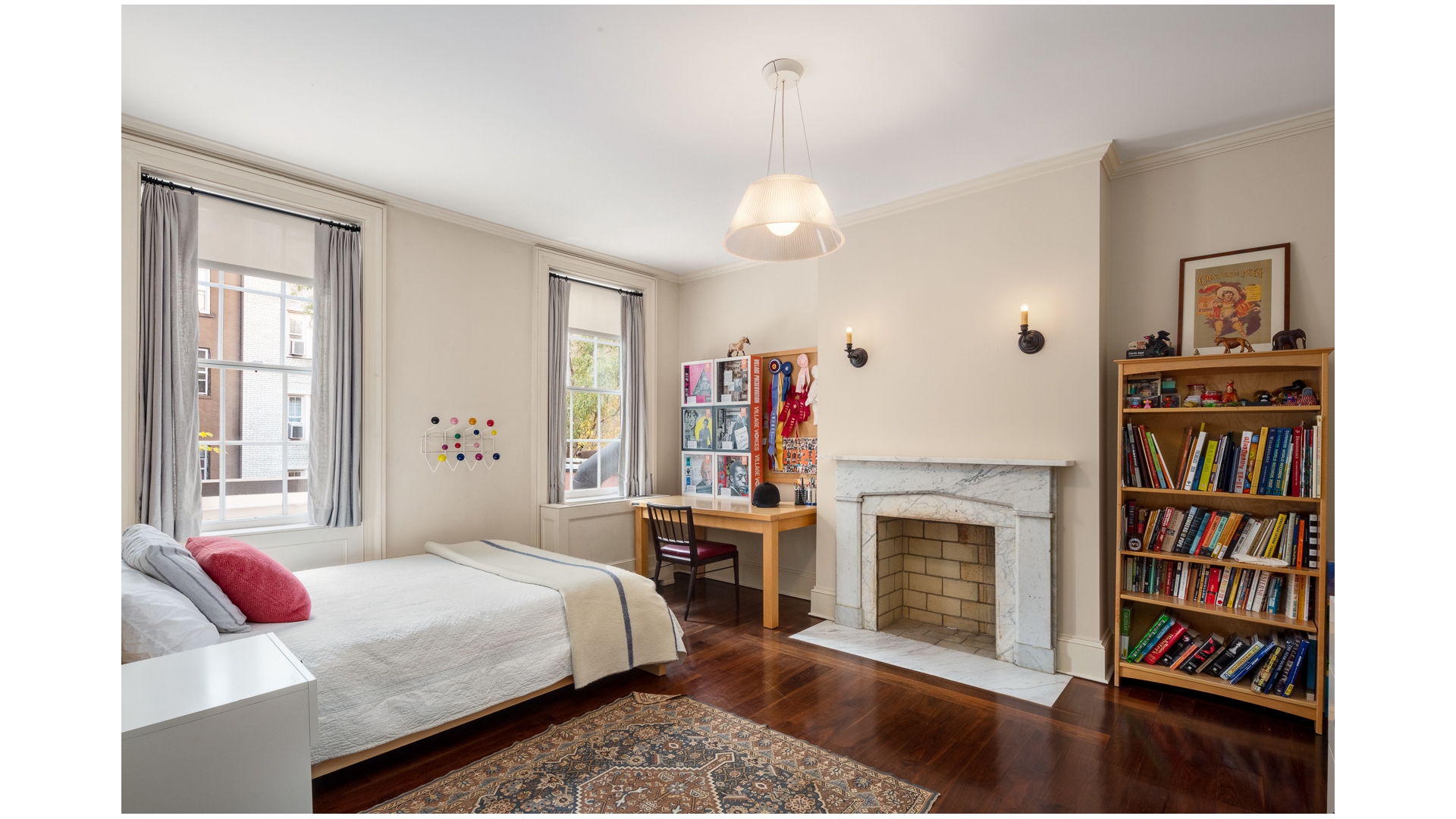 48 Jane Street Manhattan, NY 10014 - Photo 12 of 17 a bedroom with a bed and a book shelf