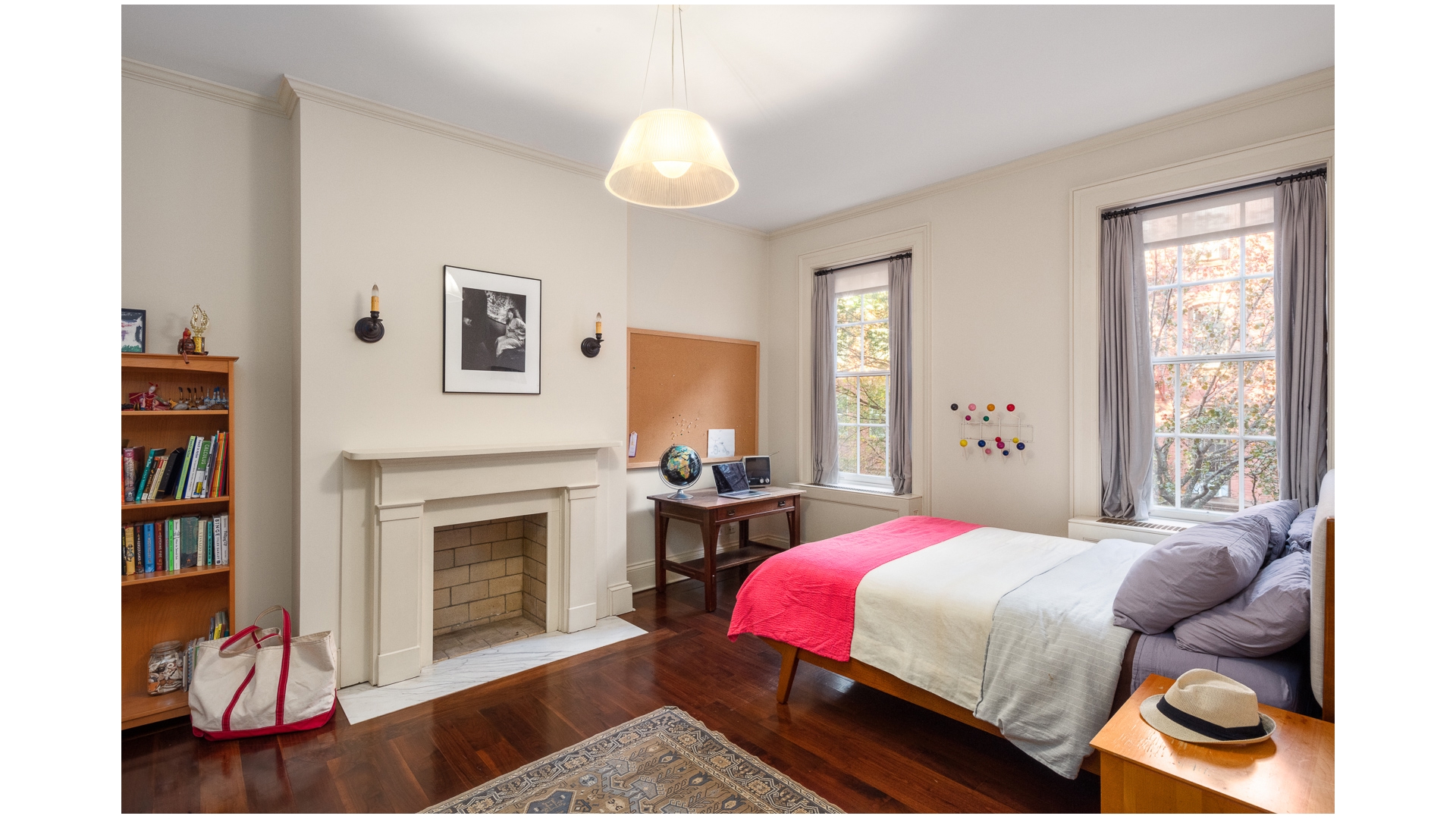 48 Jane Street Manhattan, NY 10014 - Photo 13 of 17 a bedroom with a bed and a fireplace