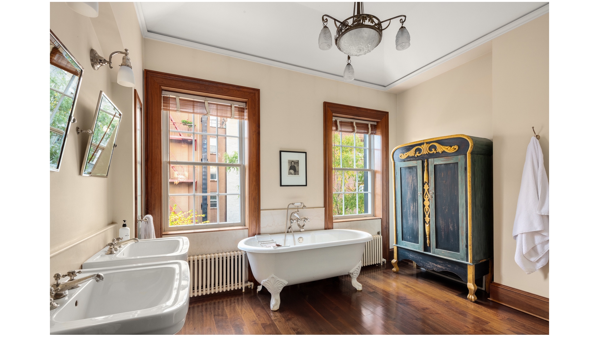 48 Jane Street Manhattan, NY 10014 - Photo 14 of 17 a bathroom with a sink mirror and a bathtub