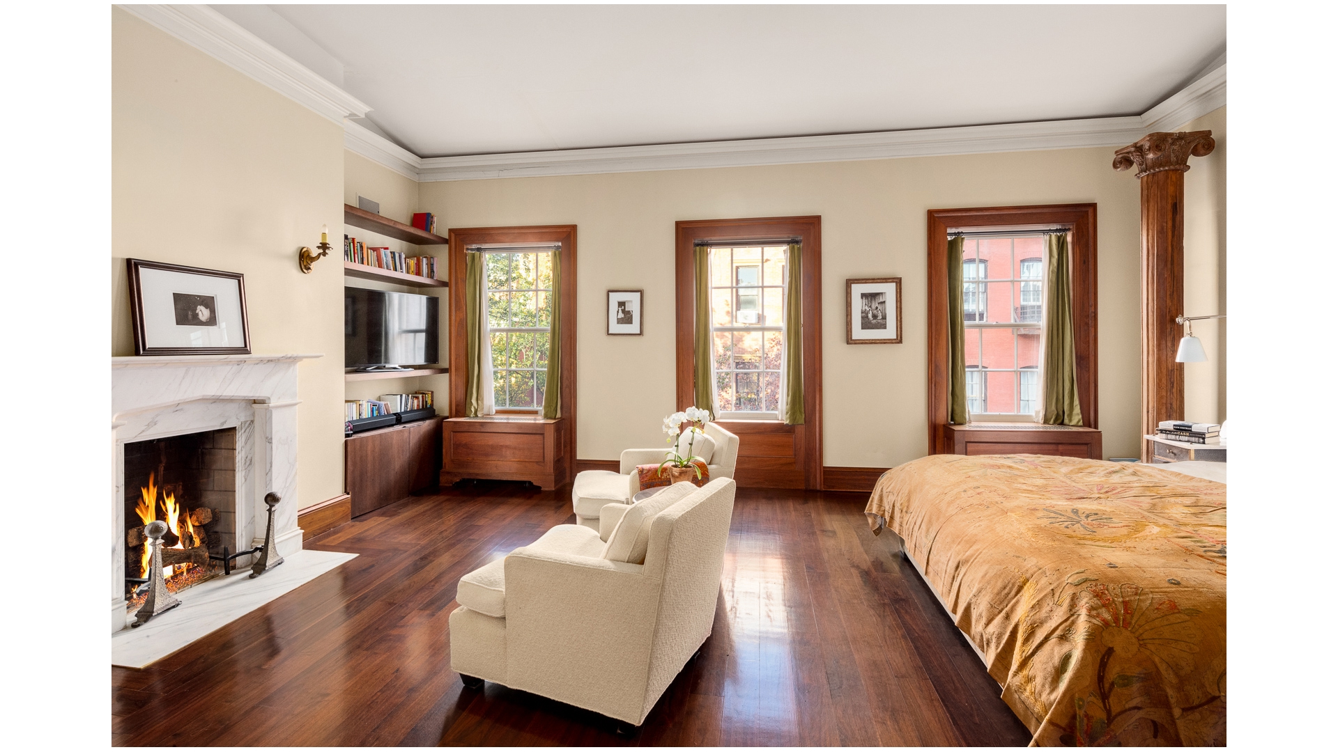 48 Jane Street Manhattan, NY 10014 - Photo 15 of 17 a bedroom with a bed wooden floor and a fireplace