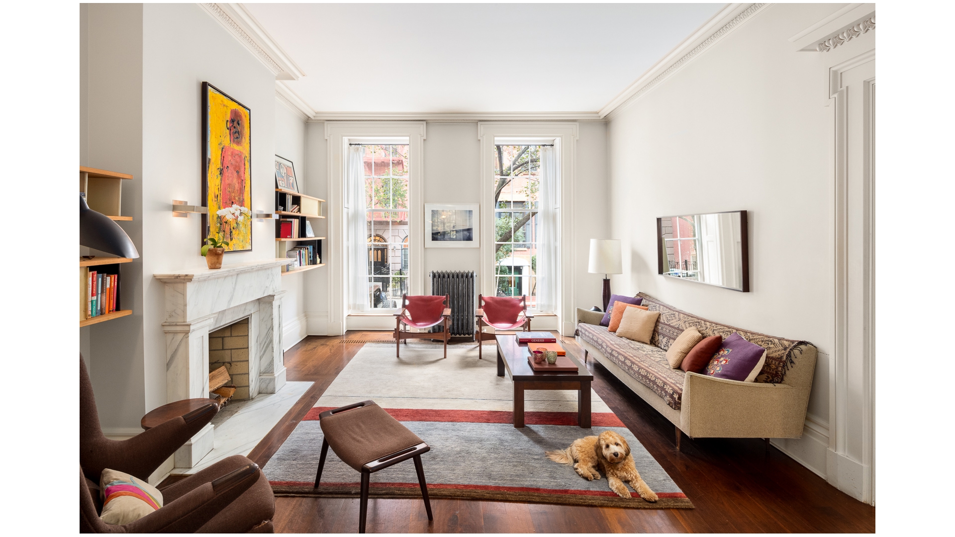 48 Jane Street Manhattan, NY 10014 - Photo 3 of 17 a living room with fireplace furniture and a floor to ceiling window