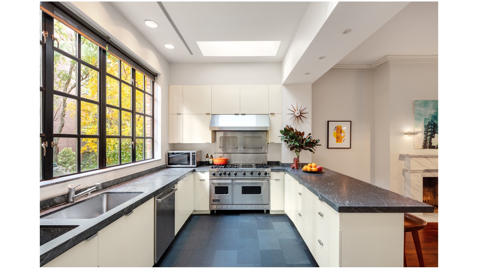 48 Jane Street Manhattan, NY 10014 - Photo 7 of 17 a kitchen with a stove a sink and a refrigerator