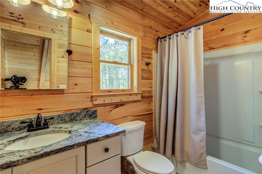 3460 South Center Church Road Thurmond, NC 28683 - Photo 40 of 50 a bathroom with a granite countertop sink toilet and shower