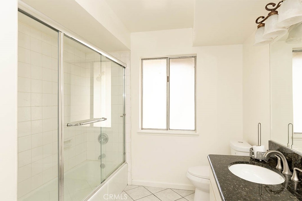 1837 Kelleher Place Placentia, CA 92870 - Photo 12 of 24 a bathroom with a granite countertop sink a mirror and a shower