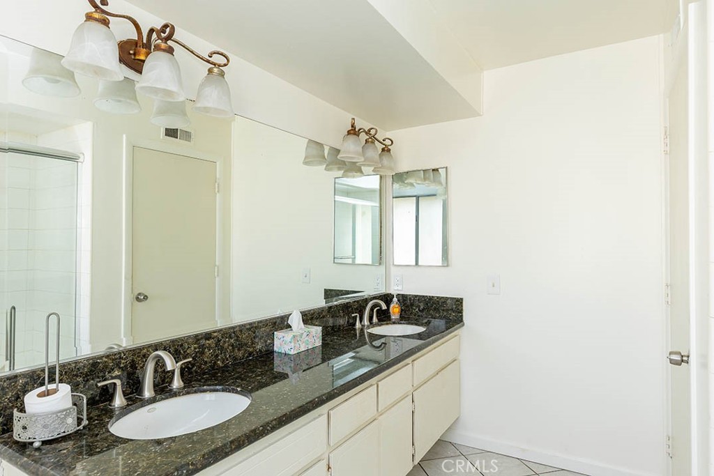 1837 Kelleher Place Placentia, CA 92870 - Photo 22 of 24 a bathroom with a granite countertop sink and a mirror