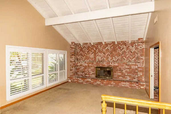 a view of wooden floor with brick walls