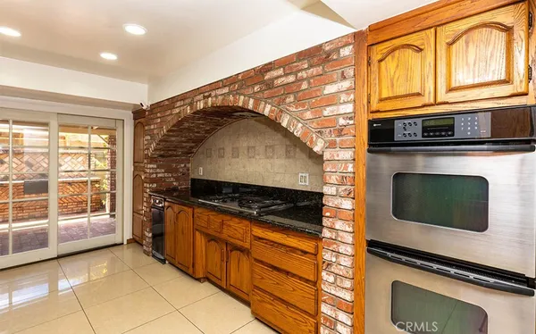 a kitchen with granite countertop a stove and a microwave
