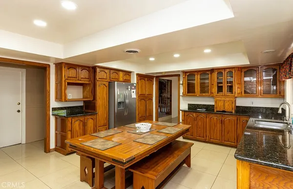 a kitchen with stainless steel appliances granite countertop a stove refrigerator and cabinets