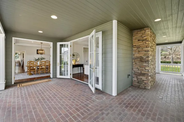 a kitchen with stainless steel appliances granite countertop a stove a sink dishwasher and a refrigerator with wooden floor