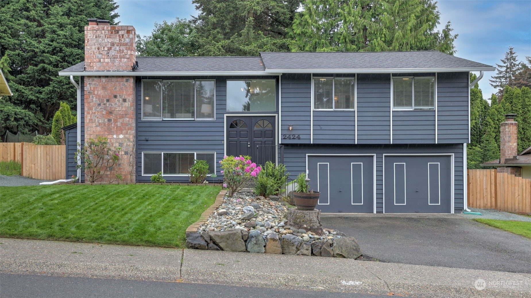 2424 170th Street Southeast Bothell, WA 98012 - Photo 1 of 40 a front view of a house with garden