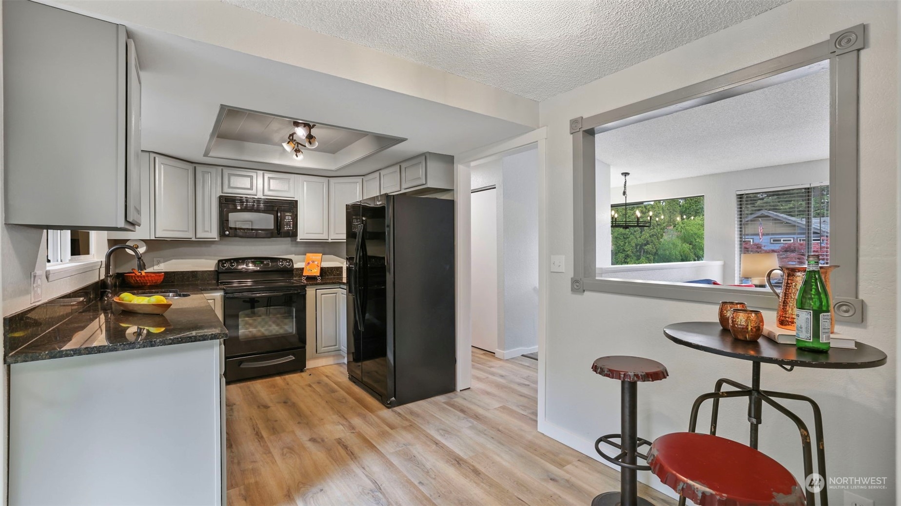 2424 170th Street Southeast Bothell, WA 98012 - Photo 14 of 40 a kitchen with granite countertop a refrigerator stove and microwave