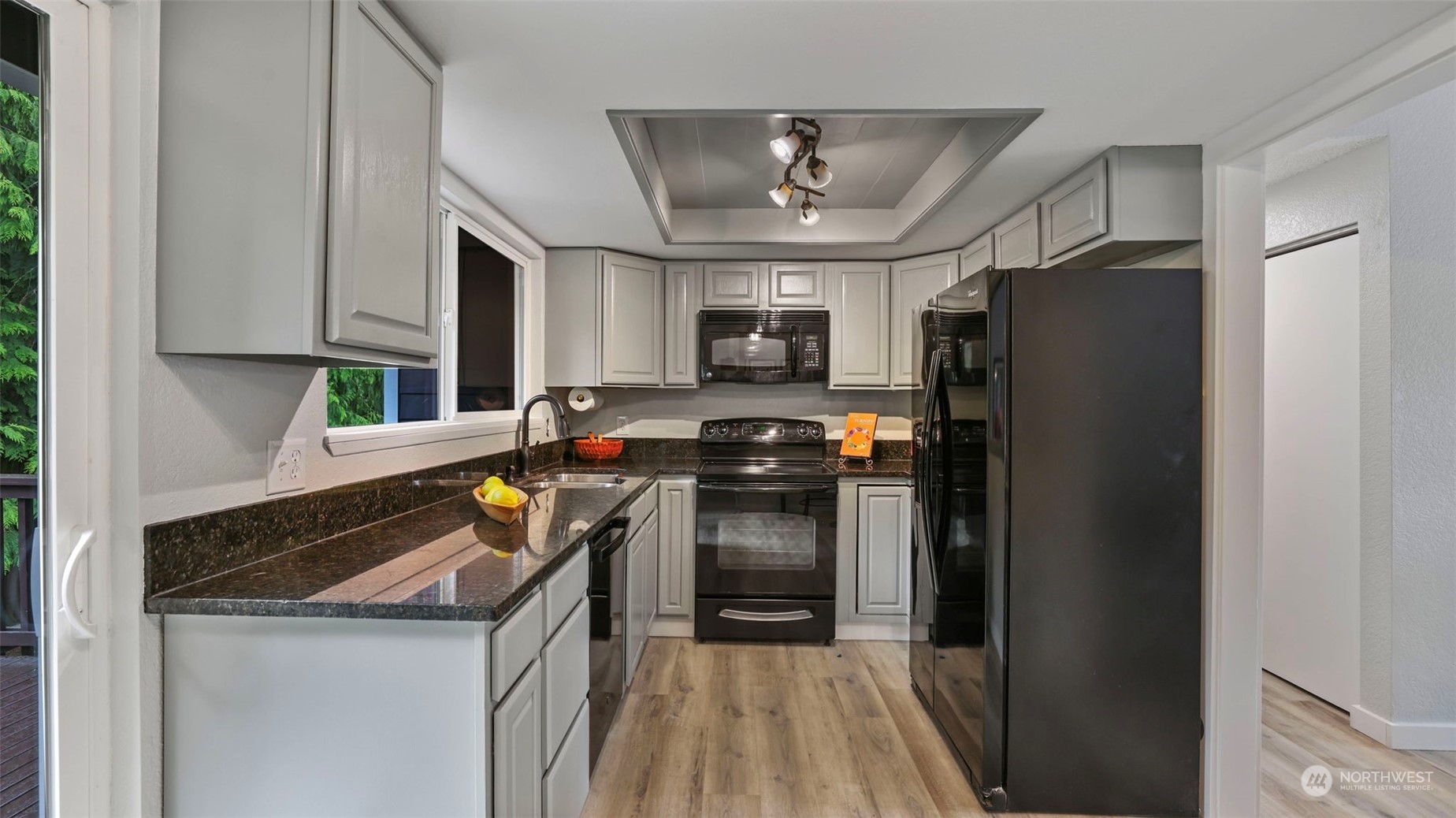 2424 170th Street Southeast Bothell, WA 98012 - Photo 15 of 40 a kitchen with stainless steel appliances granite countertop a refrigerator a stove a sink and a microwave