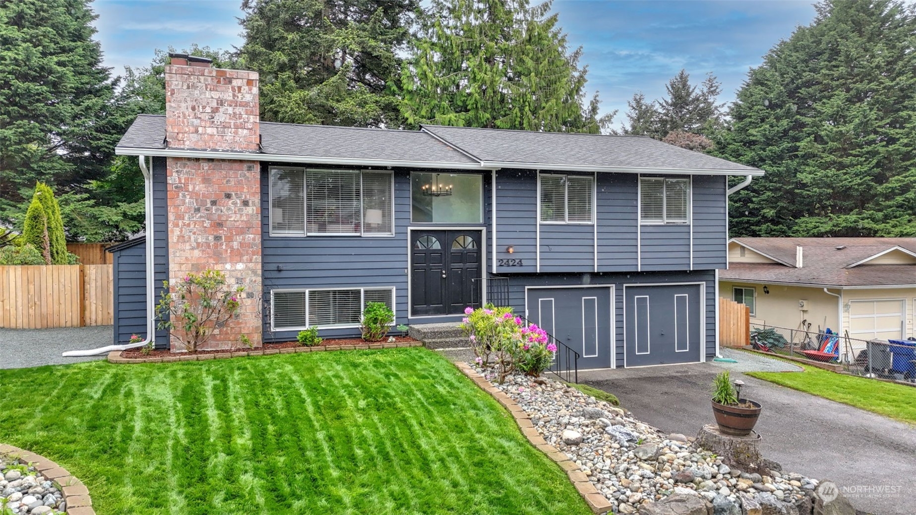 2424 170th Street Southeast Bothell, WA 98012 - Photo 3 of 40 a front view of a house with garden