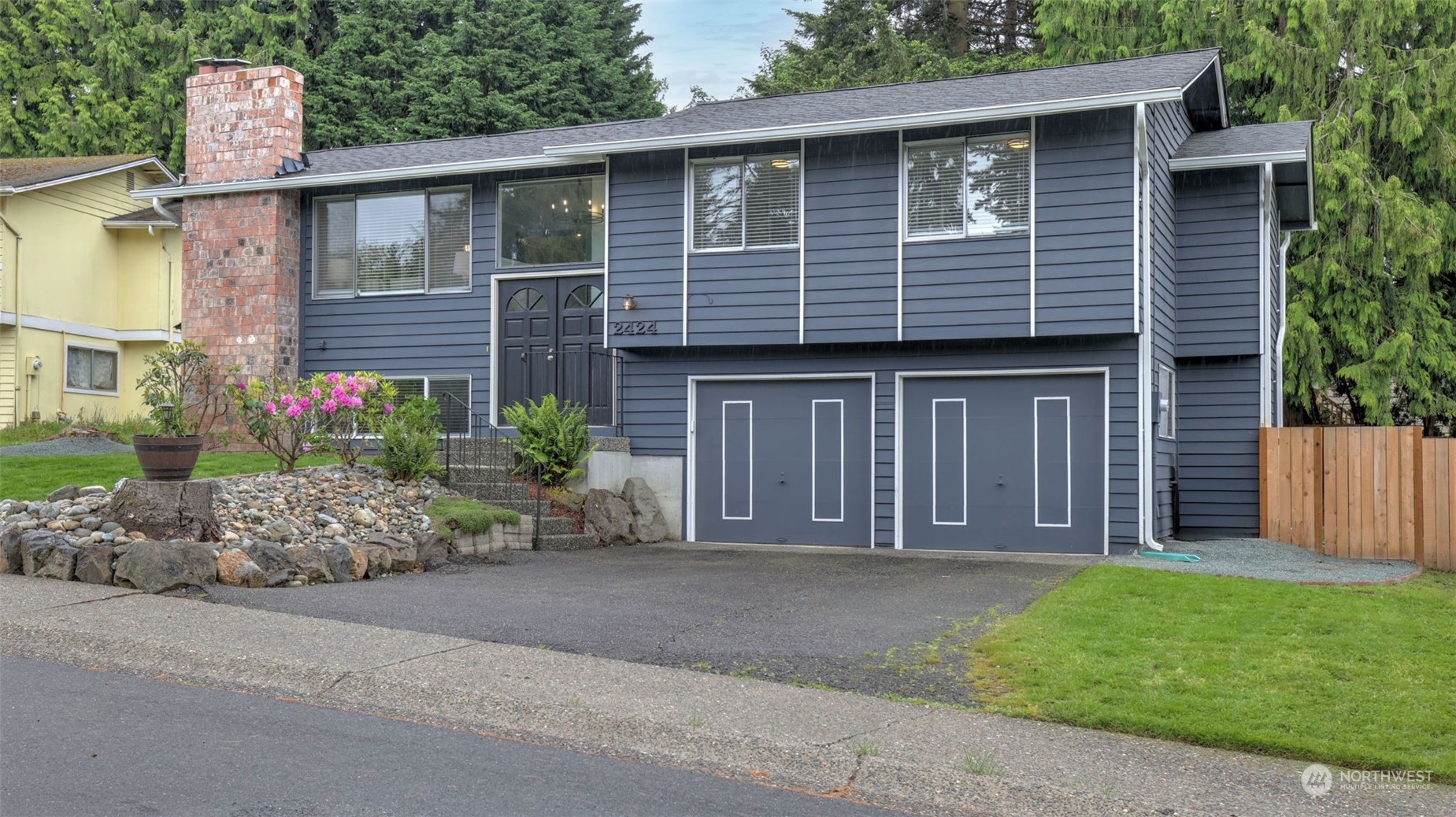 2424 170th Street Southeast Bothell, WA 98012 - Photo 6 of 40 a front view of a house with garden