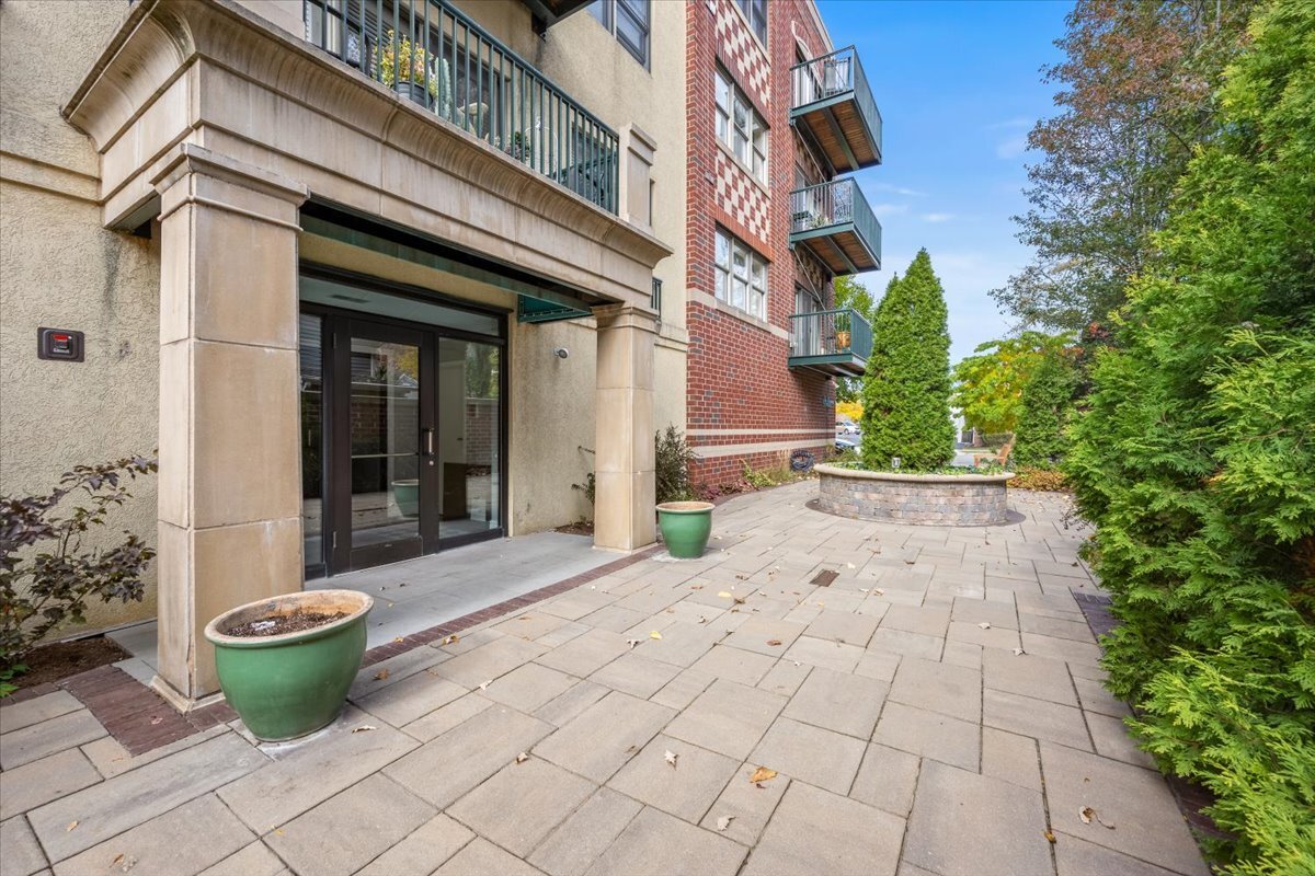 1107 Greenleaf Avenue, Unit 4G Wilmette, IL 60091 - Photo 2 of 8 a view of a patio with table and chairs potted plants
