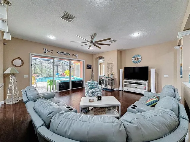 a kitchen with kitchen island granite countertop a sink and a refrigerator