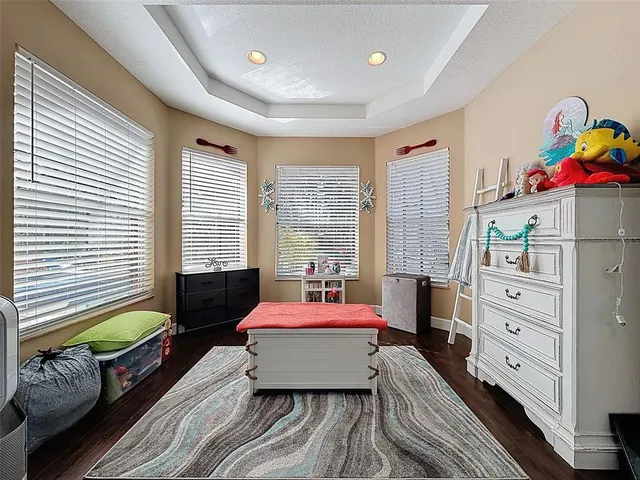 a bathroom with a granite countertop sink a toilet and a mirror