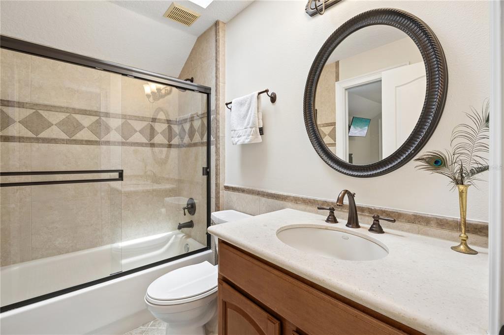 11325 Preston Cove Road Clermont, FL 34711 - Photo 37 of 58 a bathroom with a sink a toilet and a mirror
