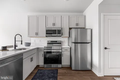 a kitchen with a white cabinets and stainless steel appliances