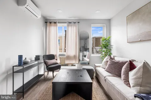 a living room with furniture lamp and window
