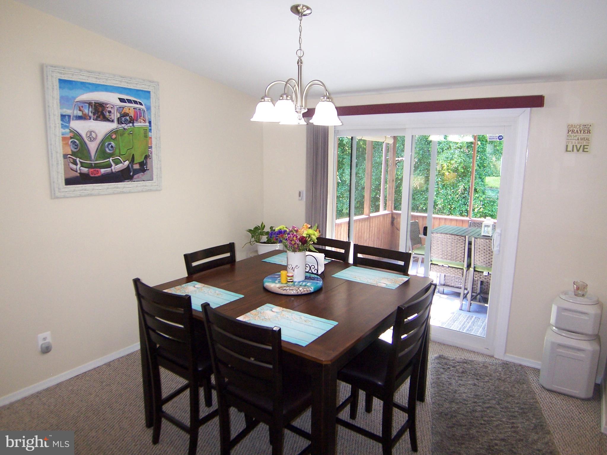 18 Yew Road Baltimore, MD 21221 - Photo 9 of 30 a view of a dining room with furniture a large window and wooden floor