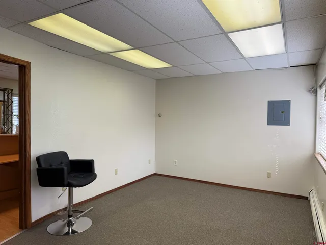 a view of room and hall with wooden floor