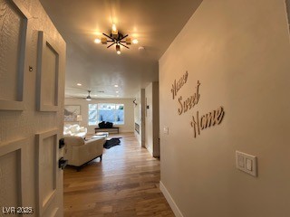 2712 Rialto Road Las Vegas, NV 89108 - Photo 49 of 54 Hall featuring wood finished floors and a chandelier