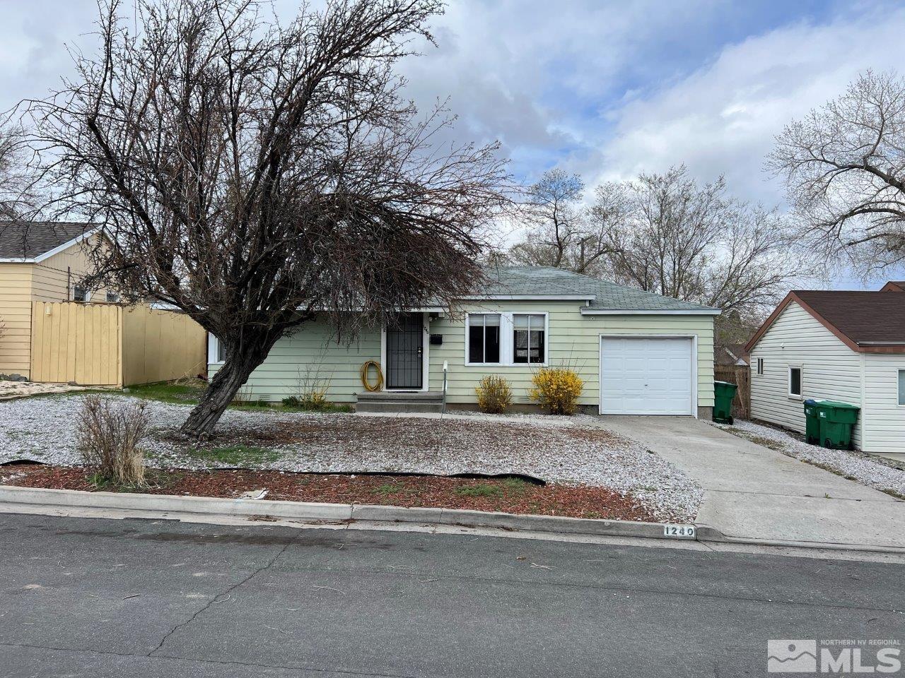 1240 Wesley Drive Reno, NV 89503 - Photo 1 of 17 a front view of a house with a yard