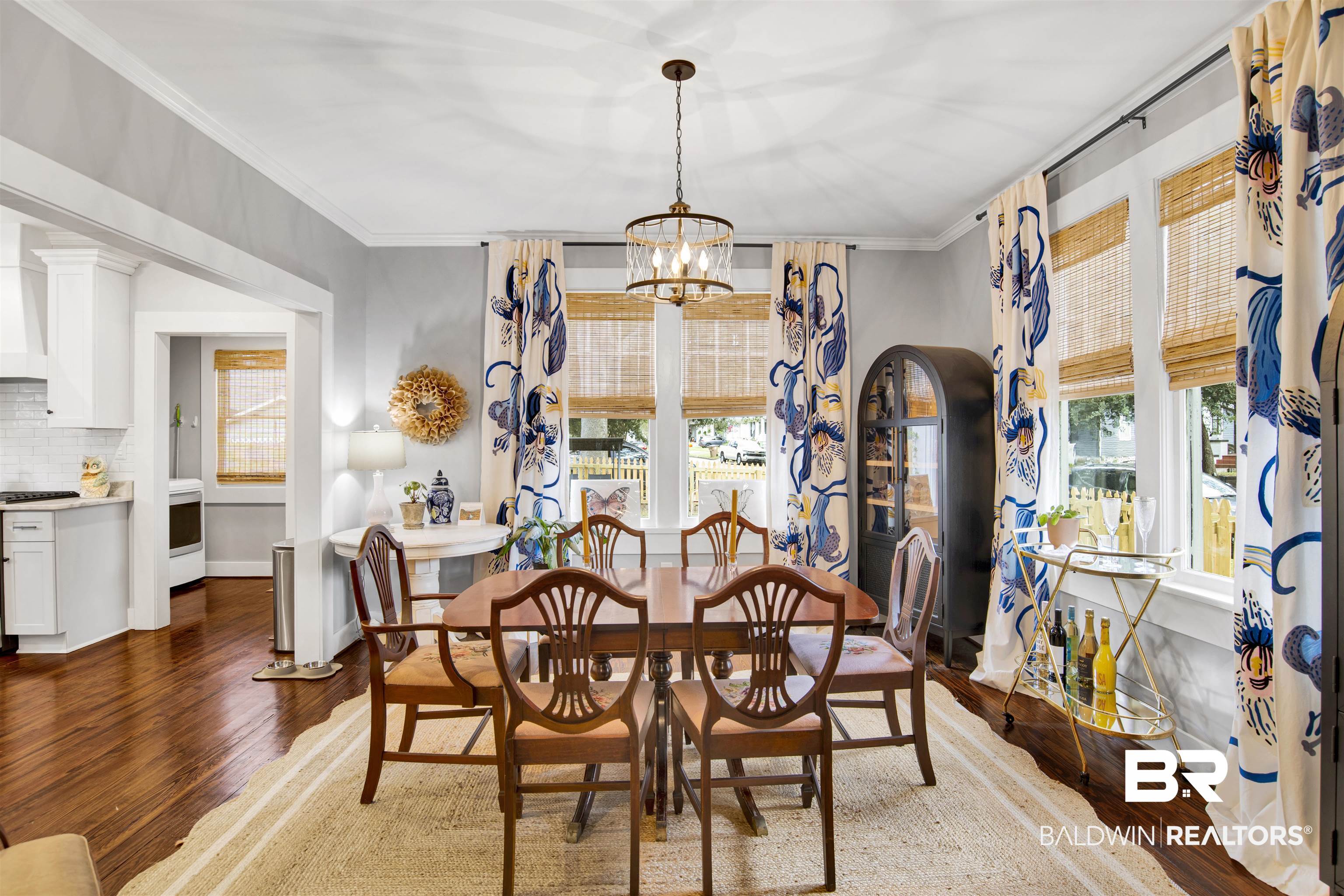 123 Macy Place Mobile, AL 36604 - Photo 27 of 35 Dining room featuring crown molding, wood finished floors, and a chandelier