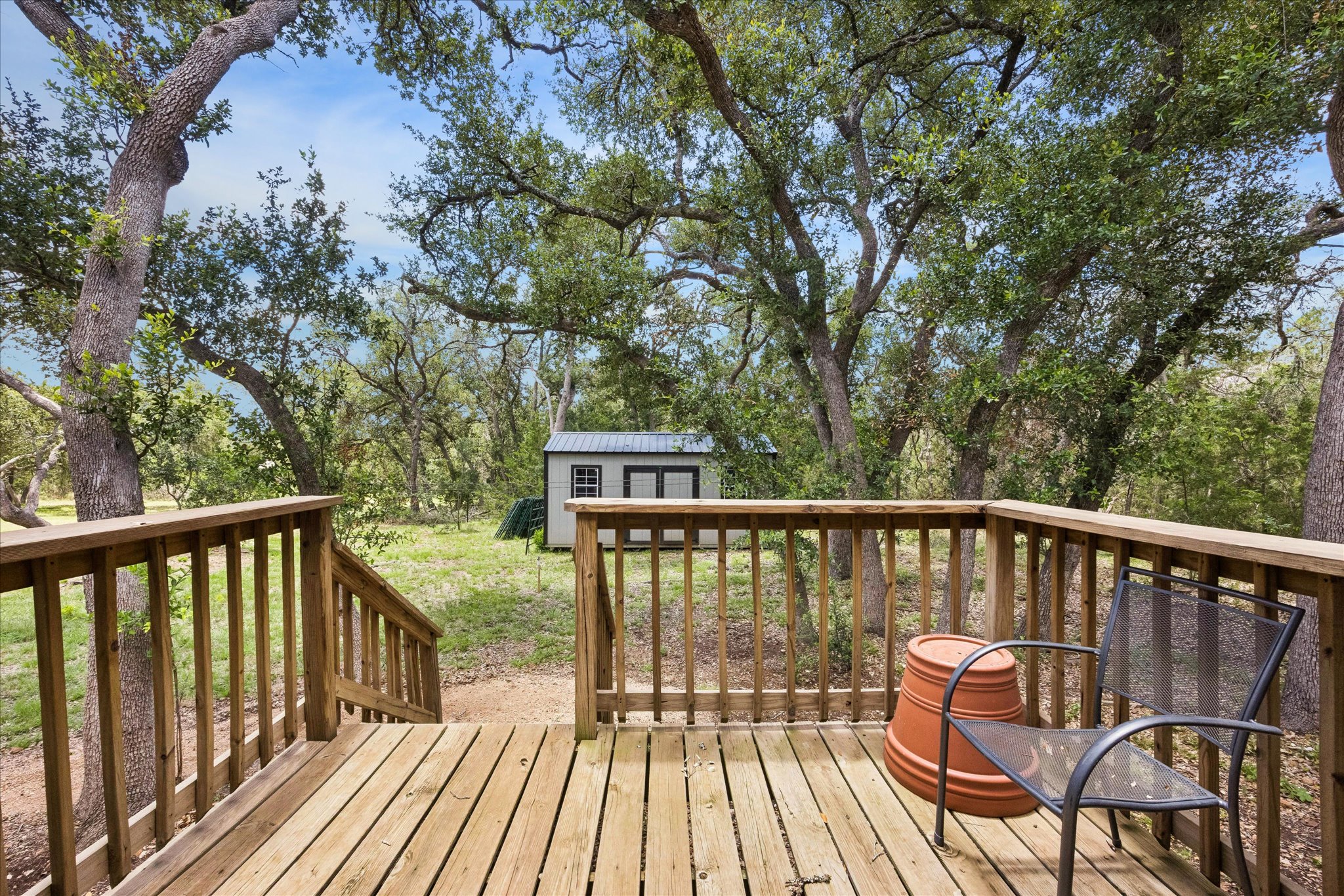 700 South Rainbow Ranch Road Wimberley, TX 78676 - Photo 23 of 29 Surrounded by mature oaks and the peaceful sounds of nature, the back porch is a front-row seat to beauty
